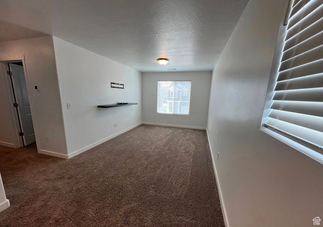 Unfurnished room featuring carpet floors and a textured ceiling | Image 11