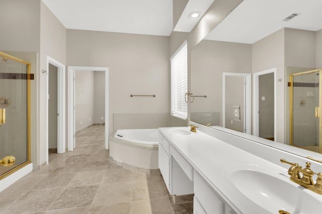 Bathroom with a shower stall, a bath, a sink, and visible vents | Image 30