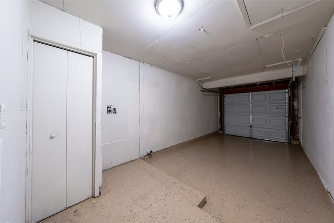Garage with baseboards | Image 28
