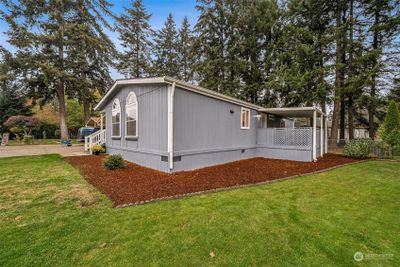 Spacious yard with trimmed trees and freshly landscaped. | Image 3