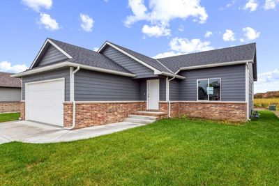 View of front of house with a garage and a front lawn | Image 1