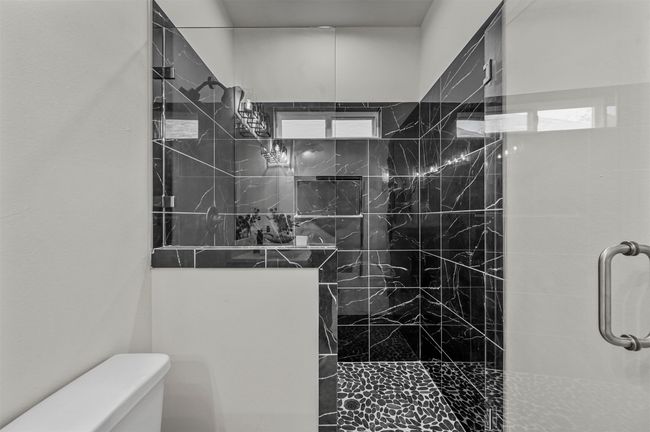 Bathroom featuring a walk in shower and toilet | Image 25