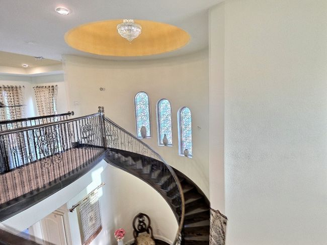 Stairway featuring a towering ceiling and a chandelier | Image 20