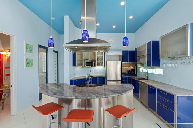 The main living space features a spacious modern kitchen. | Image 7