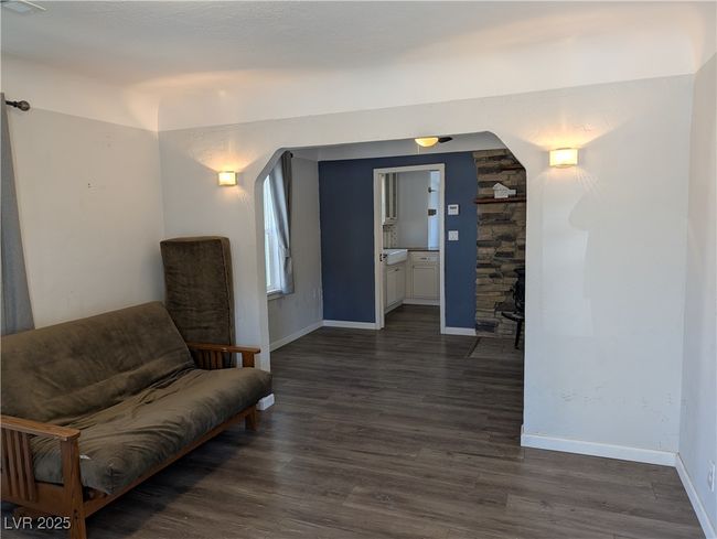 Living area featuring arched walkways, visible vents, dark wood finished floors, and baseboards | Image 4