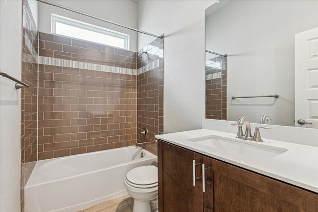 Full bath featuring vanity, toilet, and washtub / shower combination | Image 24