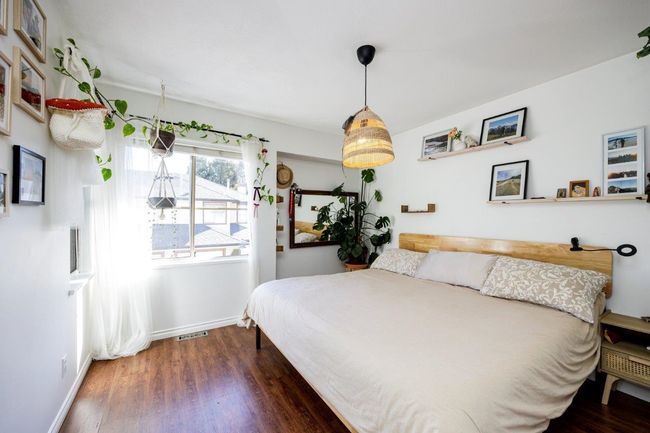 Bedroom with visible vents, wood finished floors, and baseboards | Image 14