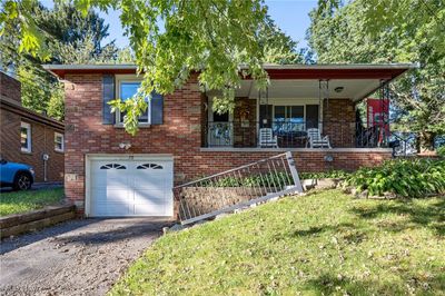 View of front of house with a porch, a garage, and a front yard | Image 2