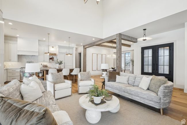 Living area featuring french doors, a notable chandelier, recessed lighting, light wood-style flooring, and baseboards | Image 7