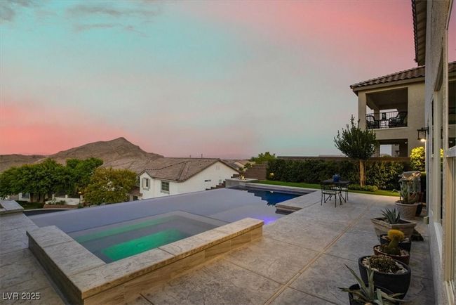 Swimming pool with an in-ground hot tub, a mountain view, and a patio area | Image 54