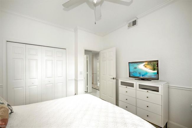 Bedroom featuring a closet, ornamental molding, visible vents, and ceiling fan | Image 19