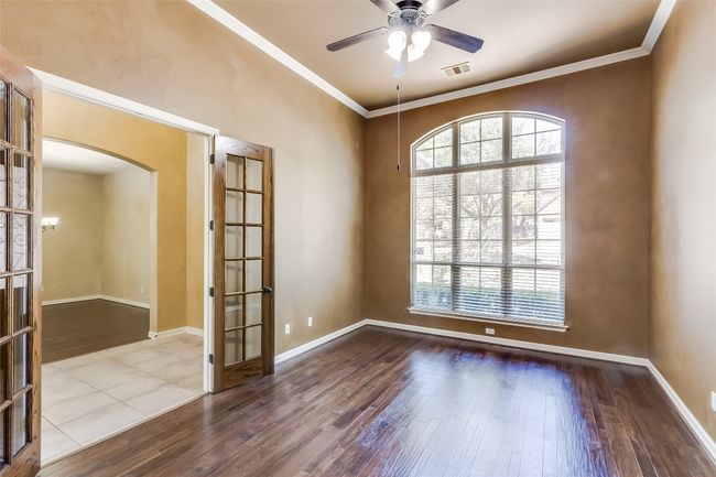 Empty room featuring visible vents, a healthy amount of sunlight, and wood finished floors | Image 7