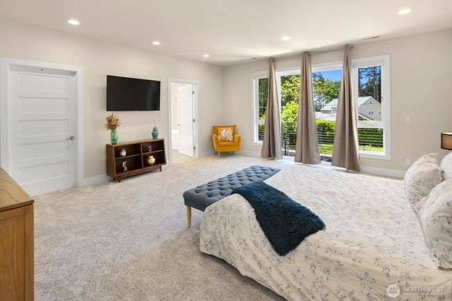 View from the primary suite entry off the upstairs landing; the doors in the background lead to the en-suite bath (right) and huge walk-in closet (left). | Image 15