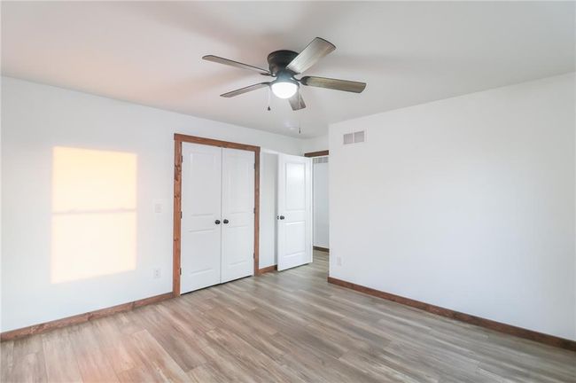 Unfurnished bedroom with ceiling fan, light hardwood / wood-style flooring, and a closet | Image 33