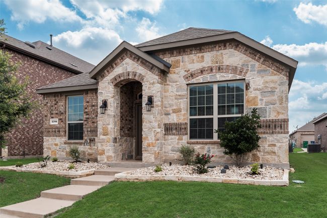 French country style house with central air condition unit, a front lawn, stone siding, and a shingled roof | Image 6