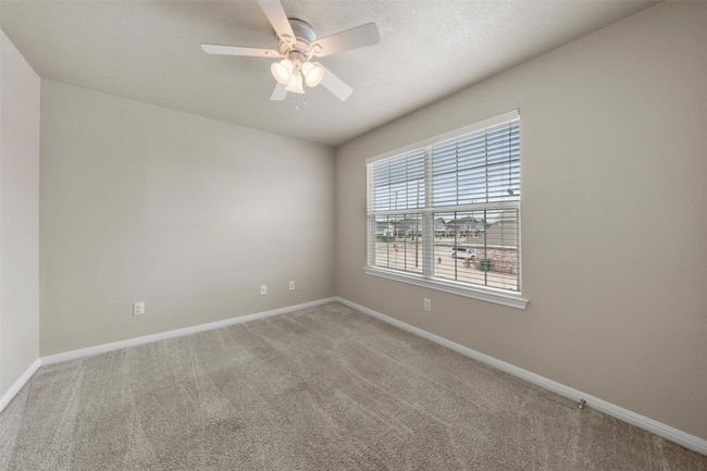 Unfurnished room with light carpet, a ceiling fan, and a textured ceiling | Image 13