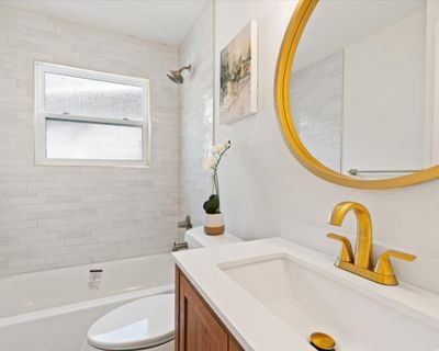 Full bathroom featuring tiled shower / bath combo, vanity, and toilet | Image 3