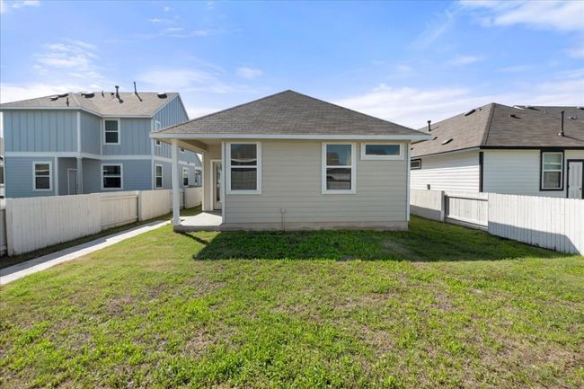 Rear view of house with a yard, roof with shingles, and a fenced backyard | Image 29