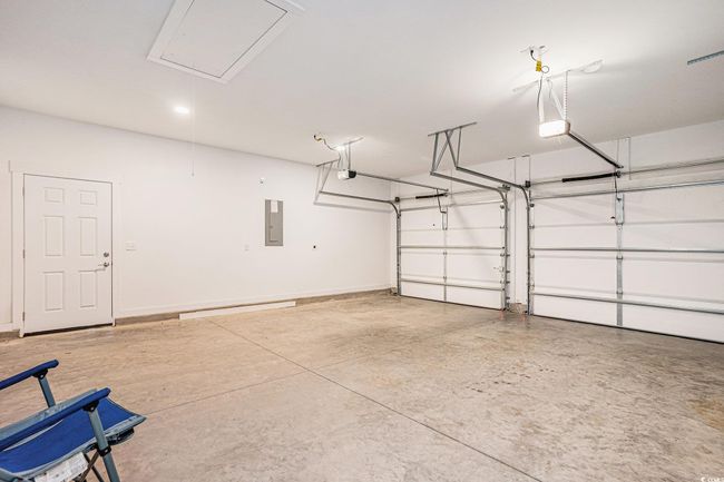 Garage with electric panel and a garage door opener | Image 24