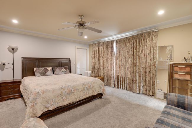 Carpeted bedroom with ceiling fan, recessed lighting, and ornamental molding | Image 18