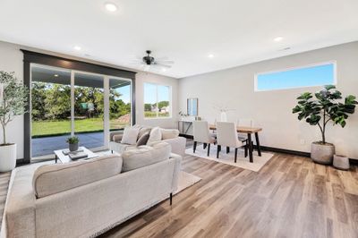 Living room featuring ceiling fan and light hardwood / wood-style flooring | Image 3