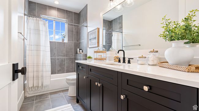 Bathroom featuring toilet, vanity, tile patterned floors, and shower / bathtub combination with curtain | Image 46