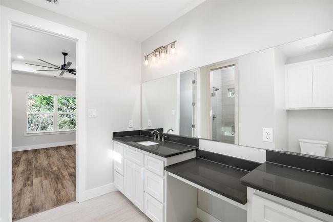 Bathroom with vanity, a shower with door, ceiling fan, toilet, and wood-type flooring | Image 22