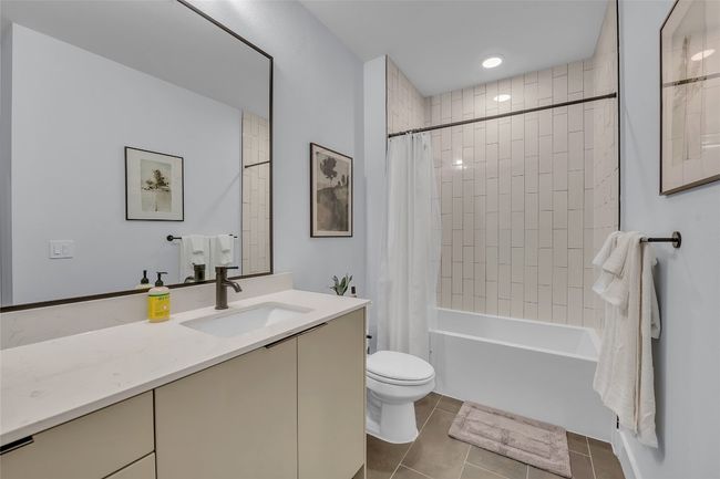 Full bath featuring vanity, tile patterned flooring, and shower / tub combo | Image 21