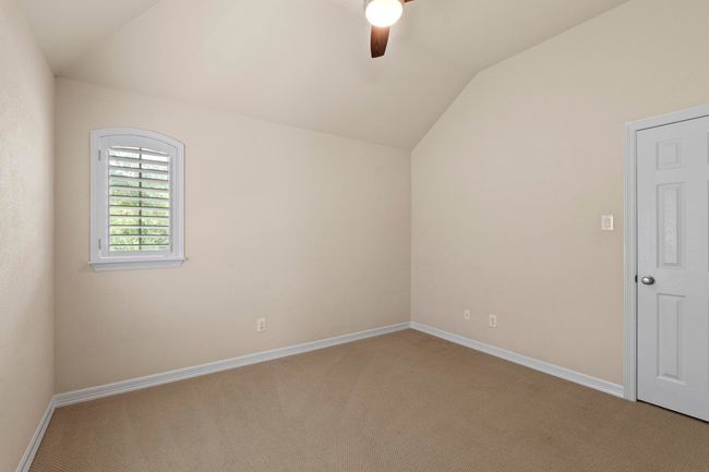Additional living space with lofted ceiling, ceiling fan, and light colored carpet | Image 33