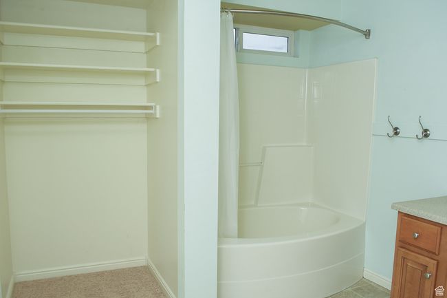 Full bath with shower / bath combination with curtain, vanity, and baseboards | Image 12