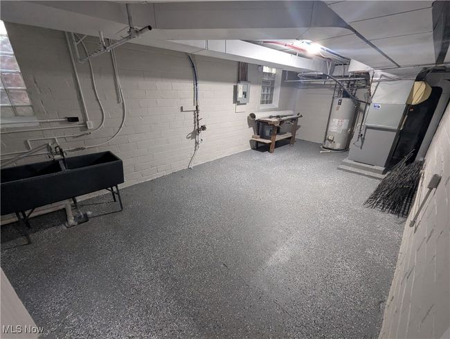 Below grade area with water heater, heating unit, electric panel, and a sink | Image 28