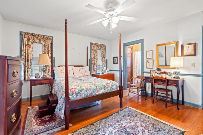 Bedroom with wood finished floors and a ceiling fan | Image 13