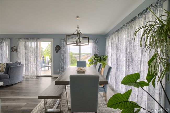 Dining room featuring wood-type flooring and an inviting chandelier | Image 32