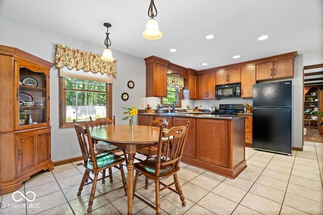 dining area featuring light tile patterned flooring and recessed lighting | Image 12