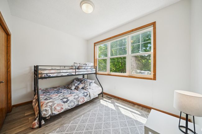 Upstairs are three bedrooms, including a spacious primary suite and laundry. | Image 25