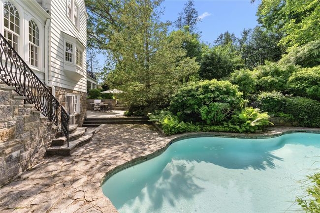 Outdoor pool with a patio area and stairs | Image 37
