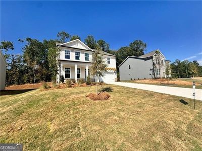 View of front of home featuring a front yard and a garage | Image 2