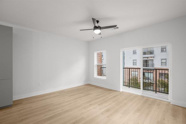 Living room with ceiling fan and wood finished floors, patio doors | Image 6