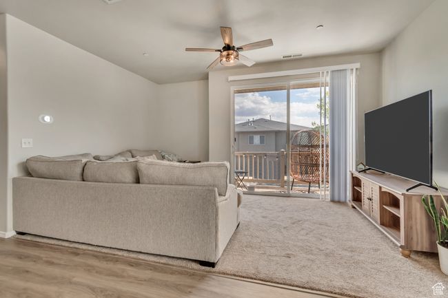 Living area with ceiling fan, visible vents, and wood finished floors | Image 4