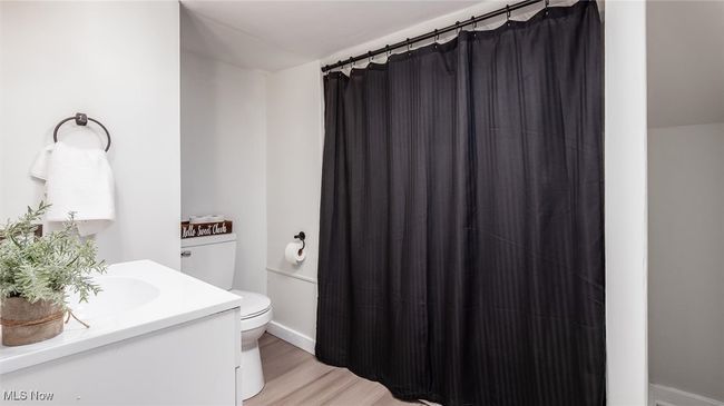 Bathroom 2 with vanity, curtained shower, and light wood-style floors | Image 14