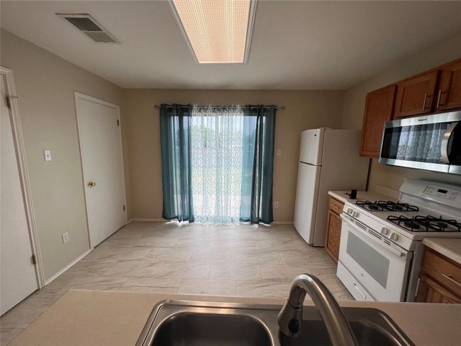 Kitchen looking towards backyard door | Image 13