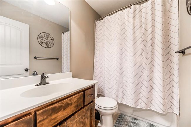 Bathroom featuring vanity, tile patterned flooring, and shower / bath combination with curtain | Image 41