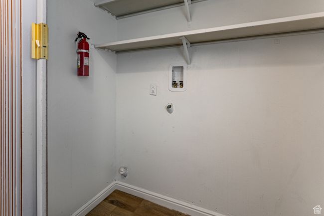 Clothes washing area with baseboards, washer hookup, and dark wood-type flooring | Image 15