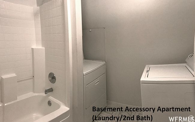 Bathroom with shower combination and washer and dryer | Image 43