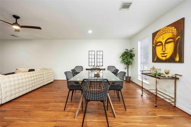 The open-concept living space flows seamlessly into the dining area, with a wide passage leading directly to the kitchen. | Image 10