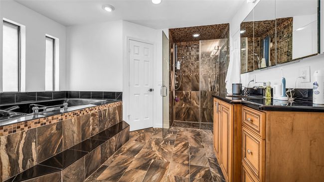 Full bath featuring a stall shower, vanity, a garden tub, marble finish flooring, and recessed lighting | Image 14