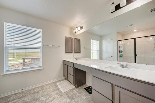 Bathroom with double vanity and a stall shower | Image 25