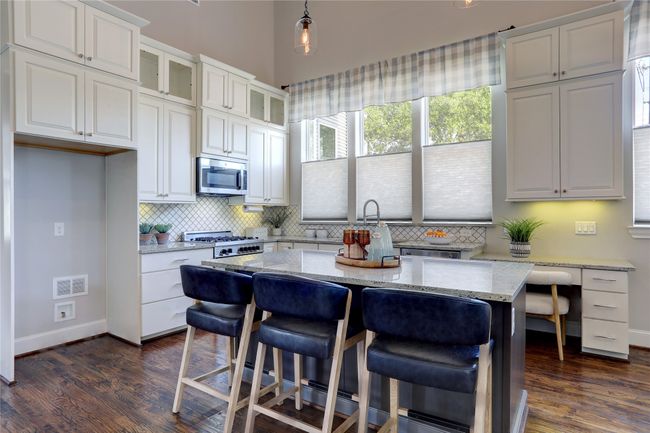 The "center of the home, " its large Kitchen island with plenty of energizing natural light. | Image 4