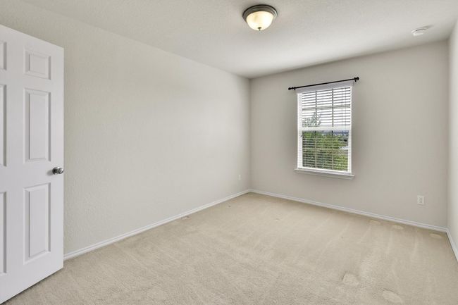 Carpeted empty room featuring baseboards | Image 16