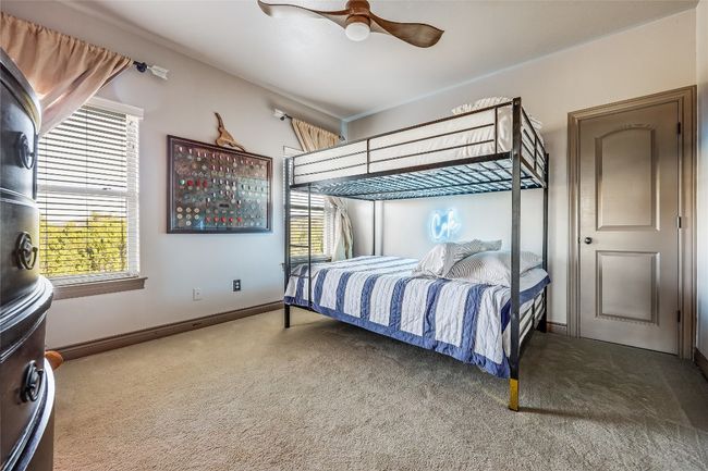 Carpeted bedroom with baseboards, multiple windows, and ceiling fan | Image 25